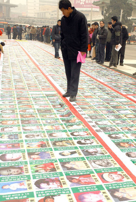 Poster with photos of 2,700 missing children