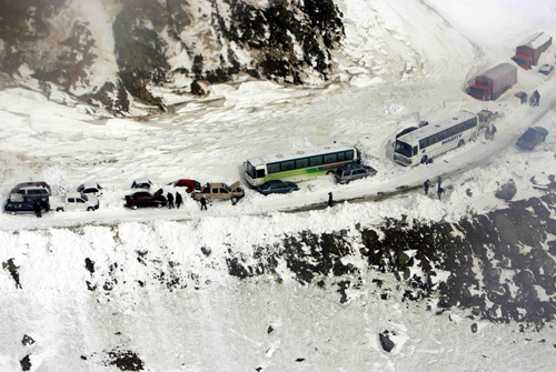 Afghans dig for survivors after avalanches kill 166