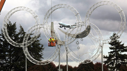 Workers put up symbol of 2010 Paralympics