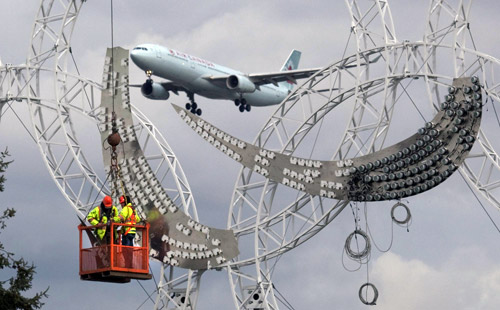 Workers put up symbol of 2010 Paralympics