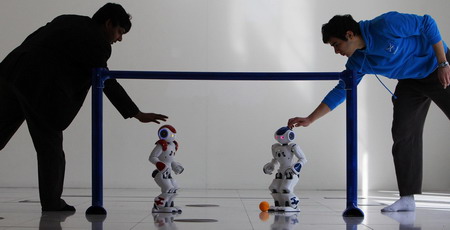 Robots play soccer in scotland