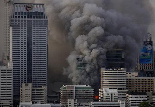 Bangkok burns as protesters surrender