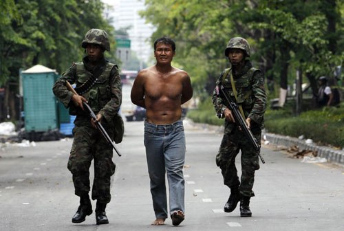Bangkok burns as protesters surrender