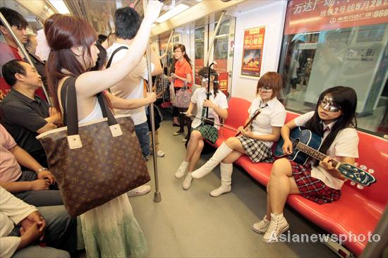 Musical 'schoolgirls' perform for commuters