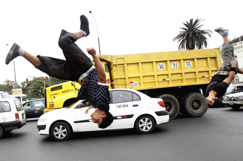 Young men play stunt to get tips from drivers