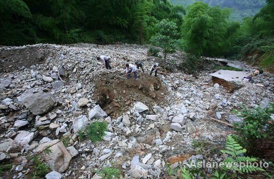 Villagers rebuild sole road after flood