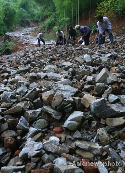 Villagers rebuild sole road after flood