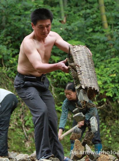 Villagers rebuild sole road after flood