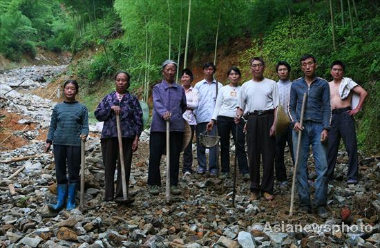 Villagers rebuild sole road after flood