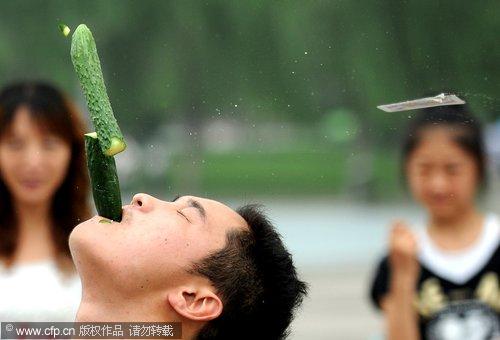 Poker card slices through a cucumber