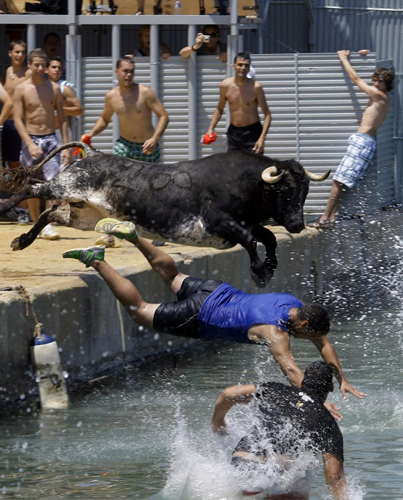 Bulls chasing revellers at Spanish festival