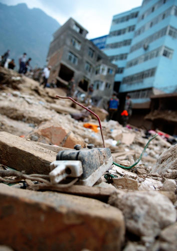 Personal items lie amid muddy ruins