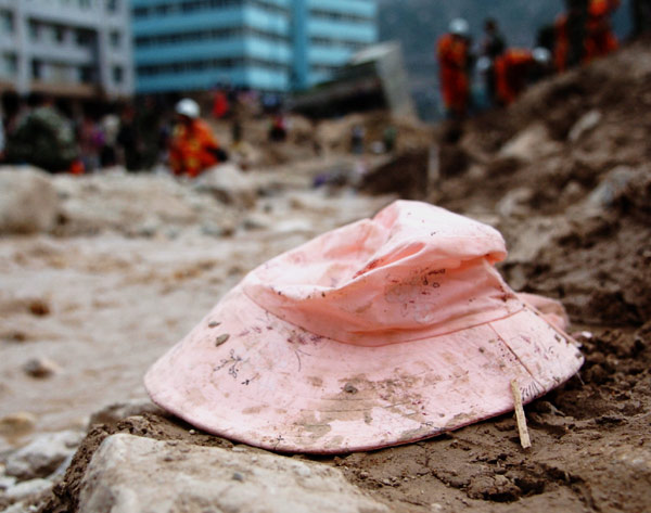 Personal items lie amid muddy ruins