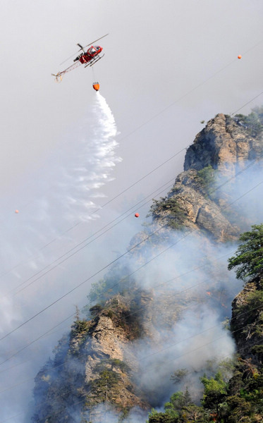 A forest fire is seen next to the southwestern village of Visp April 26, 2011, following a warm winter, combined with unusually high temperatures and no rain over the last month, the Federal Office of Meteorology and Climatology MeteoSwiss reported. Switzerland village sees forest fire