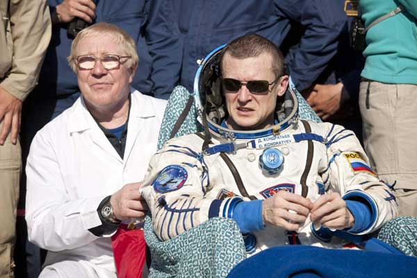 Russian cosmonaut Dmitry Kondratyev rests shortly after his landing with NASA astronaut Catherine Coleman and European Space Agency Astronaut Paolo Nespoli in Soyuz TMA-20, southeast of the town of Zhezkazgan, Kazakhstan May 24, 2011. ISS astronauts lands safely in Kazakhstan