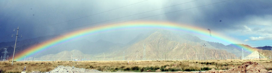 Rainbow appears over desert