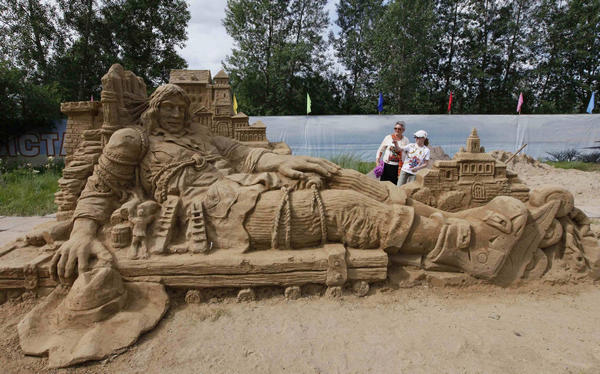 Visitors look at a sand sculpture called 'Gulliver' at a park in Russia's Siberian city of Krasnoyarsk, July 6, 2011. Sand sculptures in Russia's Krasnoyarsk