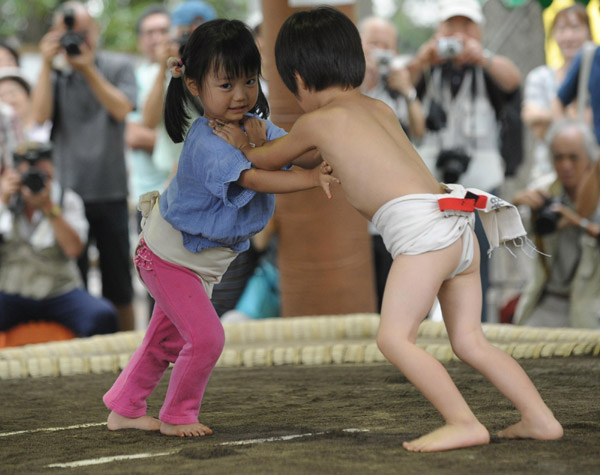 Undersize sumo wrestlers at Japan festival