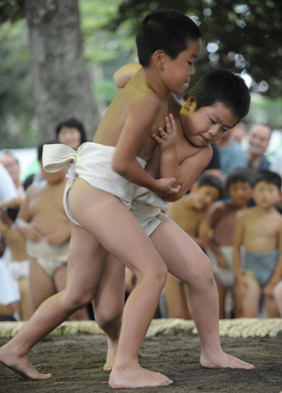 Undersize sumo wrestlers at Japan festival