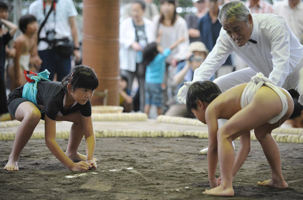 Undersize sumo wrestlers at Japan festival