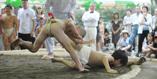 Undersize sumo wrestlers at Japan festival