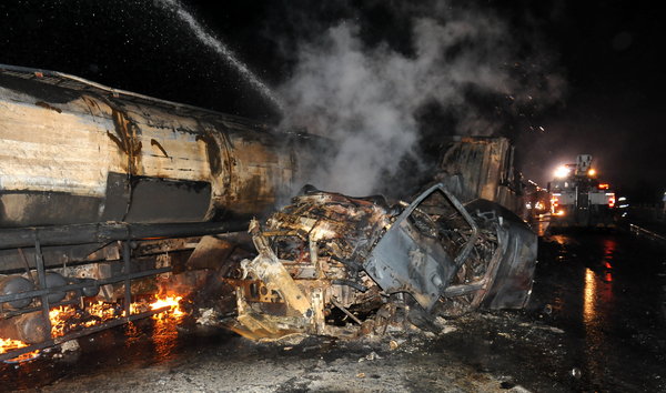 Oil tanker fire burns 9 vehicles, bridge