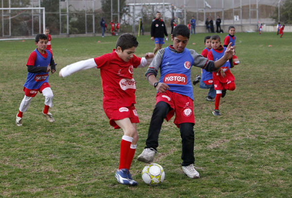 Palestinian and Israeli boys play soccer in tournament