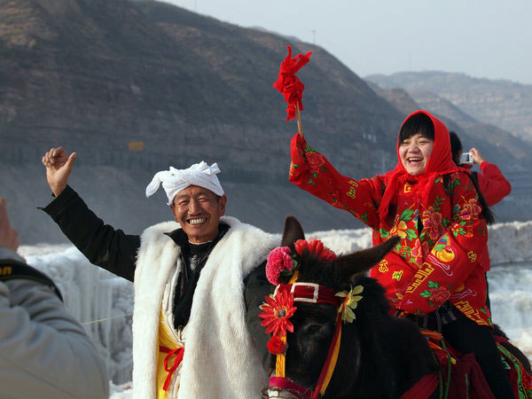 A man holding a donkey poses with a woman in front of the frozen Hukou Waterfall, a well-known scenic spot in Linfen, North China’s Shanxi province, on Feb 6, 2012. Weekly Photos: Feb 6 - 12
