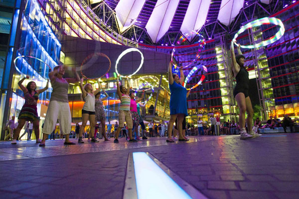 Women twirl LED-lit hula hoops in Berlin
