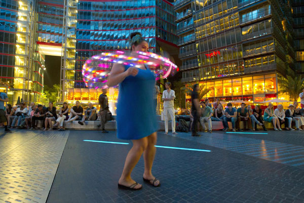 Women twirl LED-lit hula hoops in Berlin