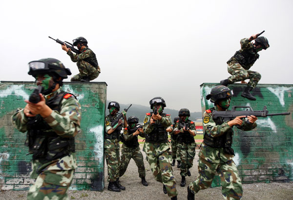 Armed policewomen train with soldiers