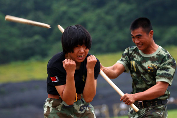 Armed policewomen train with soldiers