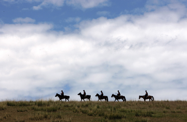 Police patrol on horseback in Xinjiang