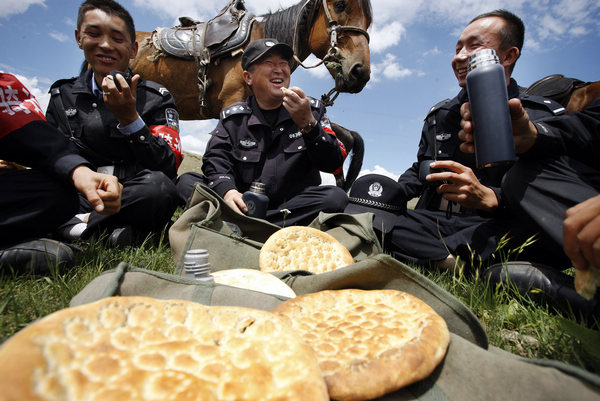 Police patrol on horseback in Xinjiang