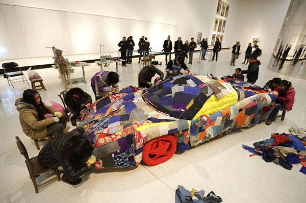 Women sew art work based on sports car in Beijing