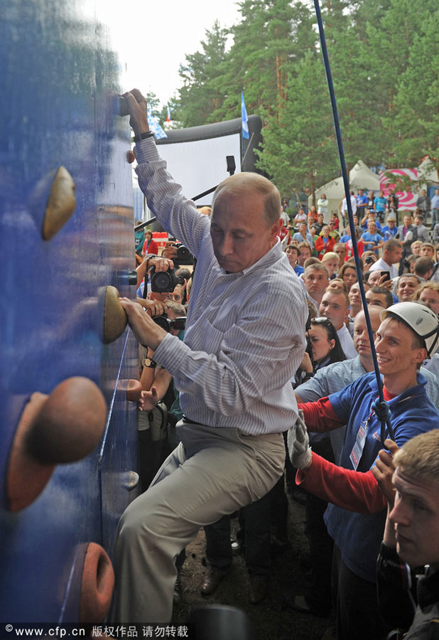 Vladimir Putin ascends a climbing wall as he attends a youth forum Seliger-2011, Aug 1, 2011. Photo special: Russia's man in action