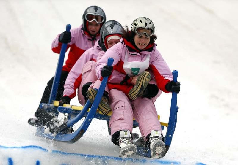 Four women ride their wooden sledge during a traditional Bavarian horn sledge race in the Alpine resort of Garmisch-Partenkirchen, Jan 6, 2013. Images of the day - Jan 6