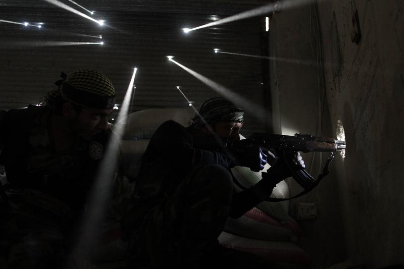 Two Syrian rebels take sniper positions at the heavily contested neighborhood of Karmal Jabl in central Aleppo, on Oct 18, 2012. War & Disaster News Singles
