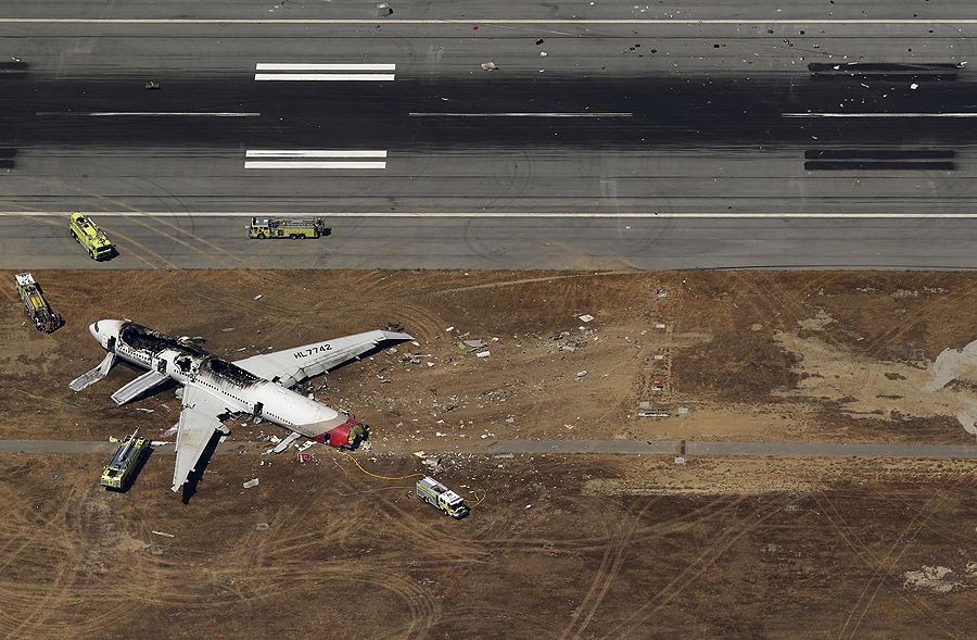 Debris from an Asiana Airlines Boeing 777 plane lies along a runway after it crashed while landing at San Francisco International Airport in California on July 6, 2013. The plane, with 307 people on board, crashed and burst into flames as it landed at San Francisco International Airport on Saturday after a flight from Seoul, and initial reports said two people were killed and more than 130 sent to hospitals. Asiana flight crashes at SFO