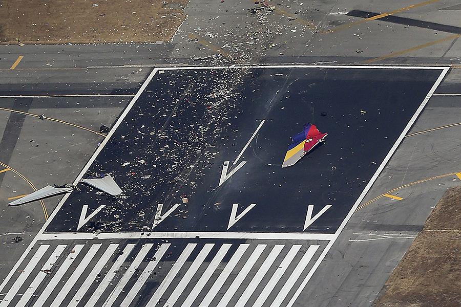 Debris from an Asiana Airlines Boeing 777 plane is seen on a runway after it crashed while landing at San Francisco International Airport in California on July 6, 2013. Two people were killed and 130 were hospitalized after the plane crash-landed at San Francisco International Airport on Saturday morning, San Francisco Fire Department Chief Joanna Hayes-White said. The figures cited by Hayes-White leave 69 people still unaccounted for in the accident. The Boeing 777, which had flown from Seoul, South Korea, was carrying 307 people. Asiana flight crashes at SFO