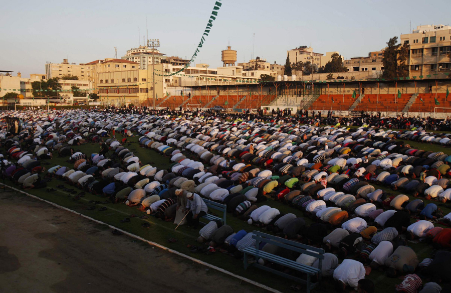 Afghans take part in morning prayers to celebrate the first day of Eid-al-Fitr outside Shah-e Doh Shamshira mosque in Kabul August 8, 2013. The Eid al-Fitr festival marks the end of the Muslim holy fasting month of Ramadan. Muslims celebrate the end of Ramadan
