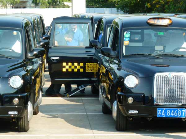 Classic British taxi cabs on road in E China