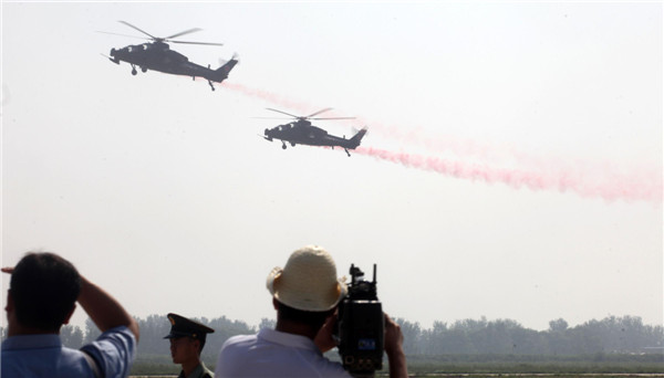 Helicopters practice acrobatic moves for expo