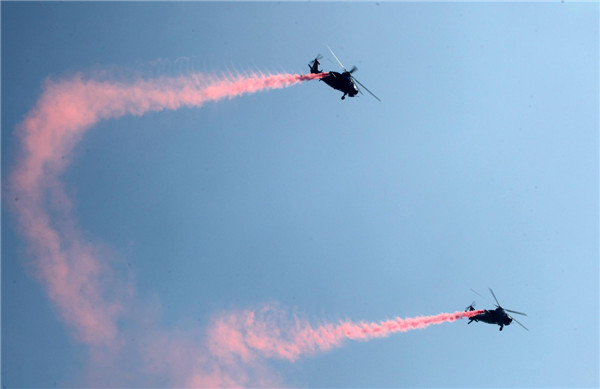 Helicopters practice acrobatic moves for expo