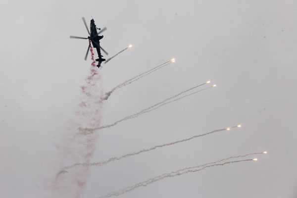 Helicopters practice acrobatic moves for expo