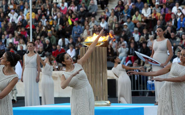 Olympic flame handed over to Russian hosts