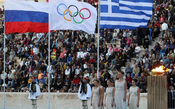 Olympic flame handed over to Russian hosts