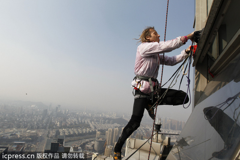 French 'spiderman' scales 288m-tall building in E China