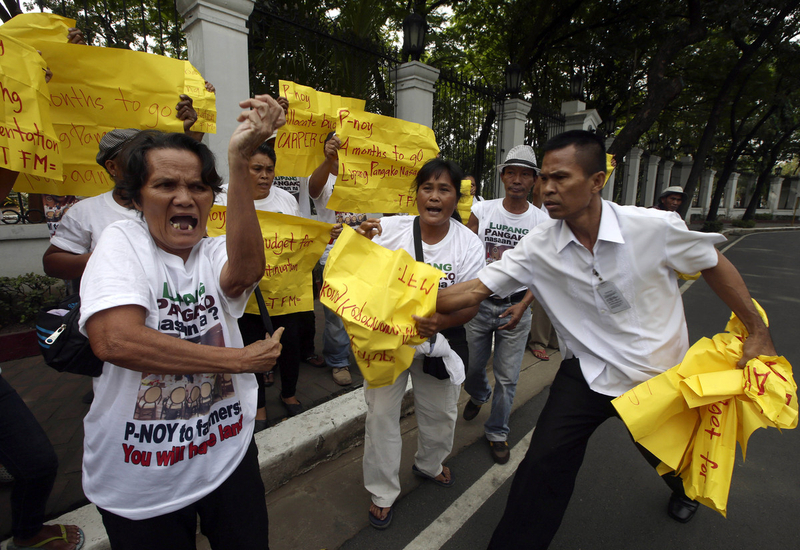 Farmer-protesters sneak into the Malacanang Palace in Manila