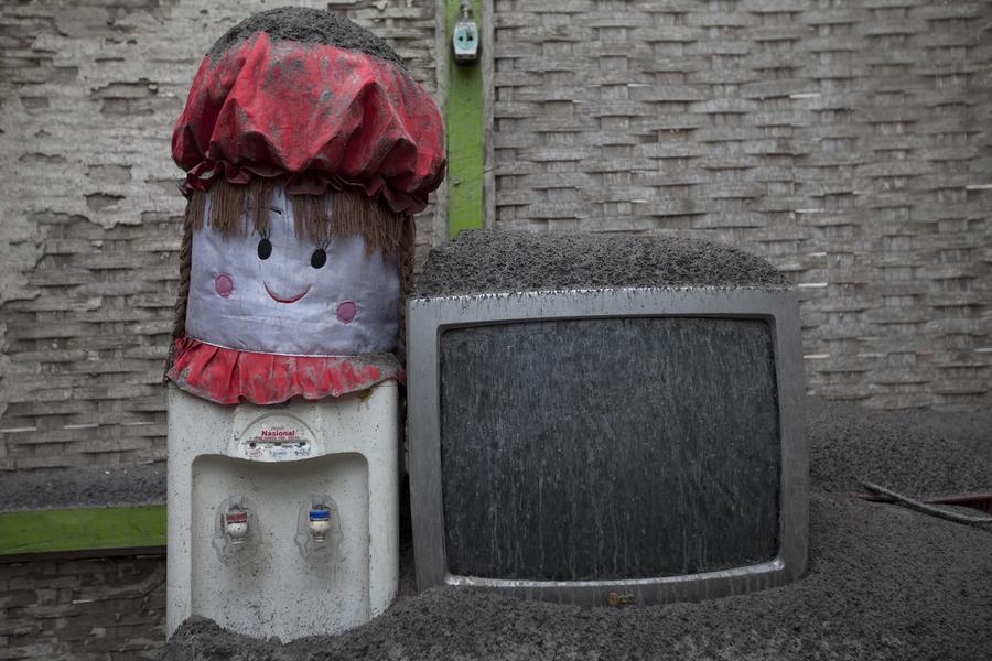 People clear volcanic ash in Indonesia